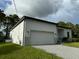 Modern house exterior with two-car garage at 13460 Tolman Ave, Port Charlotte, FL 33953