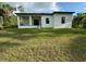 Back of house showing modern design and grassy yard at 13460 Tolman Ave, Port Charlotte, FL 33953