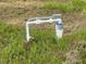 Image of a well pump system in a grassy field at 13460 Tolman Ave, Port Charlotte, FL 33953