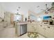 Well lit kitchen with tiled floors featuring adjacent dining and living areas at 17183 Carson Ave, Port Charlotte, FL 33948