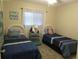 Charming bedroom with twin beds, perfect for guests or children at 25275 Rampart Blvd # 2001, Punta Gorda, FL 33983