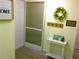 Light and bright entryway with door, hall tree, and 'welcome home' decor at 25275 Rampart Blvd # 2001, Punta Gorda, FL 33983