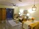 Inviting living room with a ceiling fan, floral decor, and comfortable seating at 25275 Rampart Blvd # 2001, Punta Gorda, FL 33983