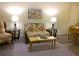 Comfortable living room with lamps, floral furniture, and a neutral carpet at 25275 Rampart Blvd # 2001, Punta Gorda, FL 33983
