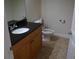 Clean bathroom with dark vanity and tile floors at 5116 Melbourne St # B105, Punta Gorda, FL 33980