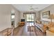 Bright living room features wood-look floors, comfy sofa, and access to a screened patio at 25275 Rampart Blvd # 1801, Punta Gorda, FL 33983