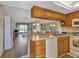 Open kitchen with wood cabinets, breakfast bar, and view of living room at 25275 Rampart Blvd # 1801, Punta Gorda, FL 33983