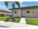 Inviting exterior of a single-story home with landscaped lawn at 25275 Rampart Blvd # 1801, Punta Gorda, FL 33983