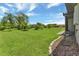 Spacious backyard with grassy area and tropical landscaping at 25275 Rampart Blvd # 1801, Punta Gorda, FL 33983