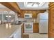 Bright kitchen with wood cabinets, white appliances, and a large island at 25275 Rampart Blvd # 1801, Punta Gorda, FL 33983