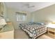 Bedroom with two twin beds, nightstands, and ceiling fan at 25275 Rampart Blvd # 1801, Punta Gorda, FL 33983