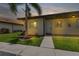Neat condo exterior with a walkway and landscaping at dusk at 25275 Rampart Blvd # 1801, Punta Gorda, FL 33983
