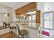 Kitchen with breakfast bar, wood cabinets and access to the exterior at 25275 Rampart Blvd # 1801, Punta Gorda, FL 33983