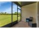 Relaxing screened porch overlooking a grassy backyard at 25275 Rampart Blvd # 2001, Punta Gorda, FL 33983