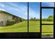 View from screened porch shows a spacious backyard at 25275 Rampart Blvd # 2001, Punta Gorda, FL 33983