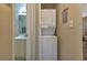 Small laundry area with stacked washer and dryer, near bathroom at 25275 Rampart Blvd # 2001, Punta Gorda, FL 33983