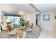 Combined living and dining area with glass-top table and wicker chairs at 3251 White Ibis Ct # A4, Punta Gorda, FL 33950