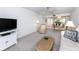 Open living room with sofa and view of dining area at 3251 White Ibis Ct # A4, Punta Gorda, FL 33950