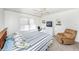 Spacious bedroom with a large bed, recliner, and ample closet space at 3251 White Ibis Ct # A4, Punta Gorda, FL 33950