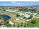 Aerial view of a villa community near a golf course and body of water at 1519 Atares Dr # 112, Punta Gorda, FL 33950