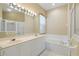 Double vanity bathroom with a large tub and shower at 1519 Atares Dr # 112, Punta Gorda, FL 33950
