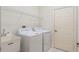 Laundry room features washer, dryer, utility sink, and shelving at 1519 Atares Dr # 112, Punta Gorda, FL 33950
