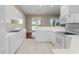 White kitchen with ample counter space and modern appliances at 1519 Atares Dr # 112, Punta Gorda, FL 33950