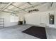 Spacious garage with storage shelving and floor mat at 1519 Atares Dr # 112, Punta Gorda, FL 33950