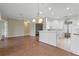 Open kitchen with white cabinets, breakfast bar, and view of dining area at 1519 Atares Dr # 112, Punta Gorda, FL 33950