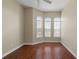 Bright bedroom with hardwood floors and three arched windows at 1519 Atares Dr # 112, Punta Gorda, FL 33950