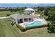 Community pool with a clubhouse and lush landscaping at 1519 Atares Dr # 112, Punta Gorda, FL 33950
