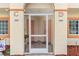 Shared entryway to units 103 and 104 with screened doors at 1186 Rio De Janeiro Ave # 104, Punta Gorda, FL 33983