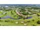 Aerial view showing community near golf course and lake at 1186 Rio De Janeiro Ave # 104, Punta Gorda, FL 33983