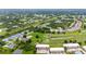 Aerial view showcasing community, golf course, and homes at 1186 Rio De Janeiro Ave # 104, Punta Gorda, FL 33983