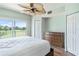Spacious main bedroom, golf course view, ceiling fan, and wood floors at 1186 Rio De Janeiro Ave # 104, Punta Gorda, FL 33983