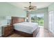 Main bedroom with golf course view and ceiling fan at 1186 Rio De Janeiro Ave # 104, Punta Gorda, FL 33983