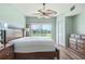 Bright main bedroom with golf course view and ceiling fan at 1186 Rio De Janeiro Ave # 104, Punta Gorda, FL 33983