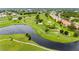 Aerial view of community with golf course, lake, and residential buildings at 1186 Rio De Janeiro Ave # 104, Punta Gorda, FL 33983
