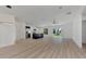 Open concept living and kitchen with island and sliding glass doors at 3847 E Price Blvd, North Port, FL 34288