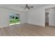 Bright bedroom featuring wood-look flooring and sliding glass doors to backyard at 3847 E Price Blvd, North Port, FL 34288