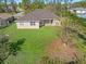 Spacious backyard with a large tree and grassy lawn at 1516 Natrona Dr, North Port, FL 34286