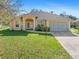 Single-story home with a two-car garage and nicely landscaped lawn at 1516 Natrona Dr, North Port, FL 34286