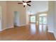 Bright living room featuring hardwood floors, vaulted ceilings, and a ceiling fan at 1516 Natrona Dr, North Port, FL 34286