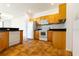 Kitchen with light wood cabinets, tile floors, and appliances at 1516 Natrona Dr, North Port, FL 34286