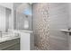 Modern bathroom with frameless glass shower, decorative accent tile, and grey vanity with marble countertop at 16077 Coruna Ct, Punta Gorda, FL 33955