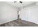 Bedroom featuring a ceiling fan, spacious closet and gray wood-look floors at 16077 Coruna Ct, Punta Gorda, FL 33955