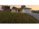 Inviting single-story home featuring a two-car garage, neutral stucco, and a modern stone-accented entrance at 16077 Coruna Ct, Punta Gorda, FL 33955
