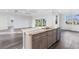 Open kitchen with a center island, stainless steel appliances, and easy access to the backyard and living areas at 16077 Coruna Ct, Punta Gorda, FL 33955