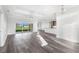 Bright and airy living room featuring hardwood floors, recessed lighting, and sliding glass doors to the backyard at 16077 Coruna Ct, Punta Gorda, FL 33955