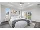 Serene main bedroom with tray ceilings, neutral decor, and a sliding glass door to the backyard at 16077 Coruna Ct, Punta Gorda, FL 33955